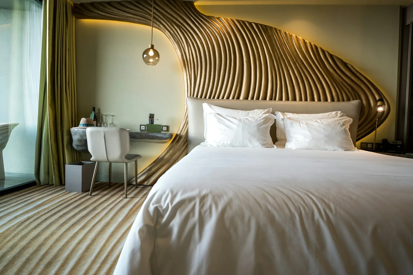 Quietly sculpted details in a warm, contemporary boutique hotel suite
